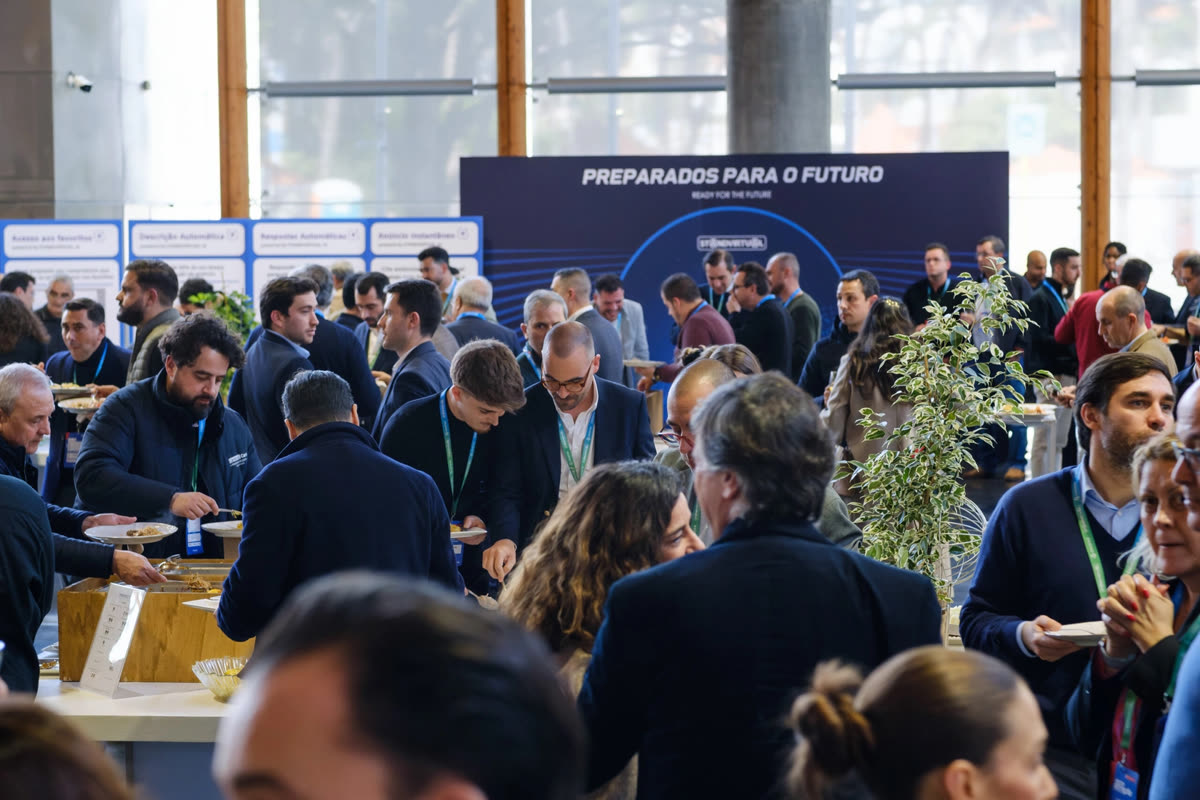 Networking in front of the Ready for the Future backdrop